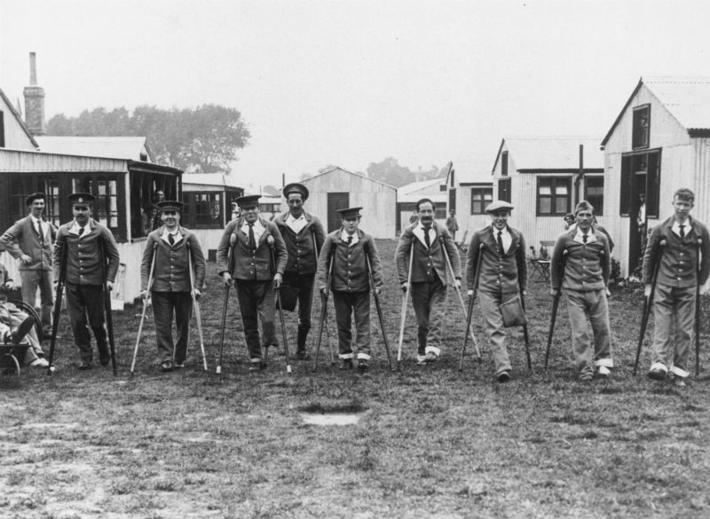 Wounded and disabled soldiers on crutches standing in a line, England, WWI. c. Science Museum, SSPL