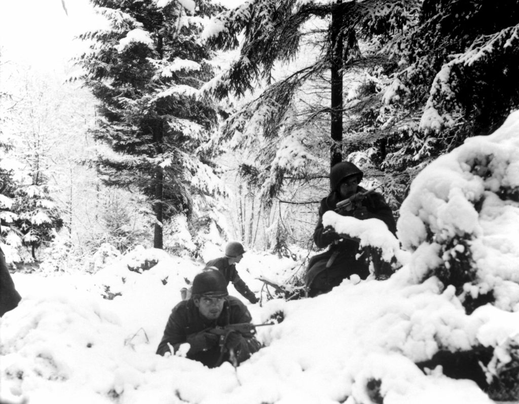 American infantrymen of the 290th Regiment fight in fresh snowfall near Amonines, Belgium.  January 4, 1945.  Public Domain, NARA