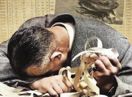 A man dejectedly rests his head on a table wearing a suit and holding ticker tape. Behind him is a sinking merchant ship and a document in German