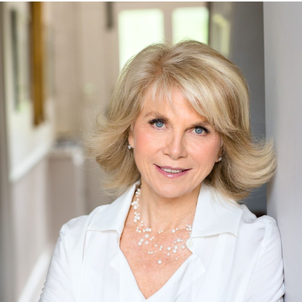 A portrait photograph and Anne Sebba wearing white.